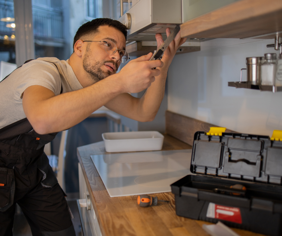 handyman repairing a cabinet with tools on the counter